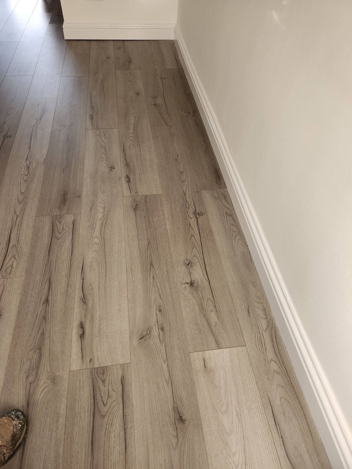 New wood-effect flooring with crisp white skirting board