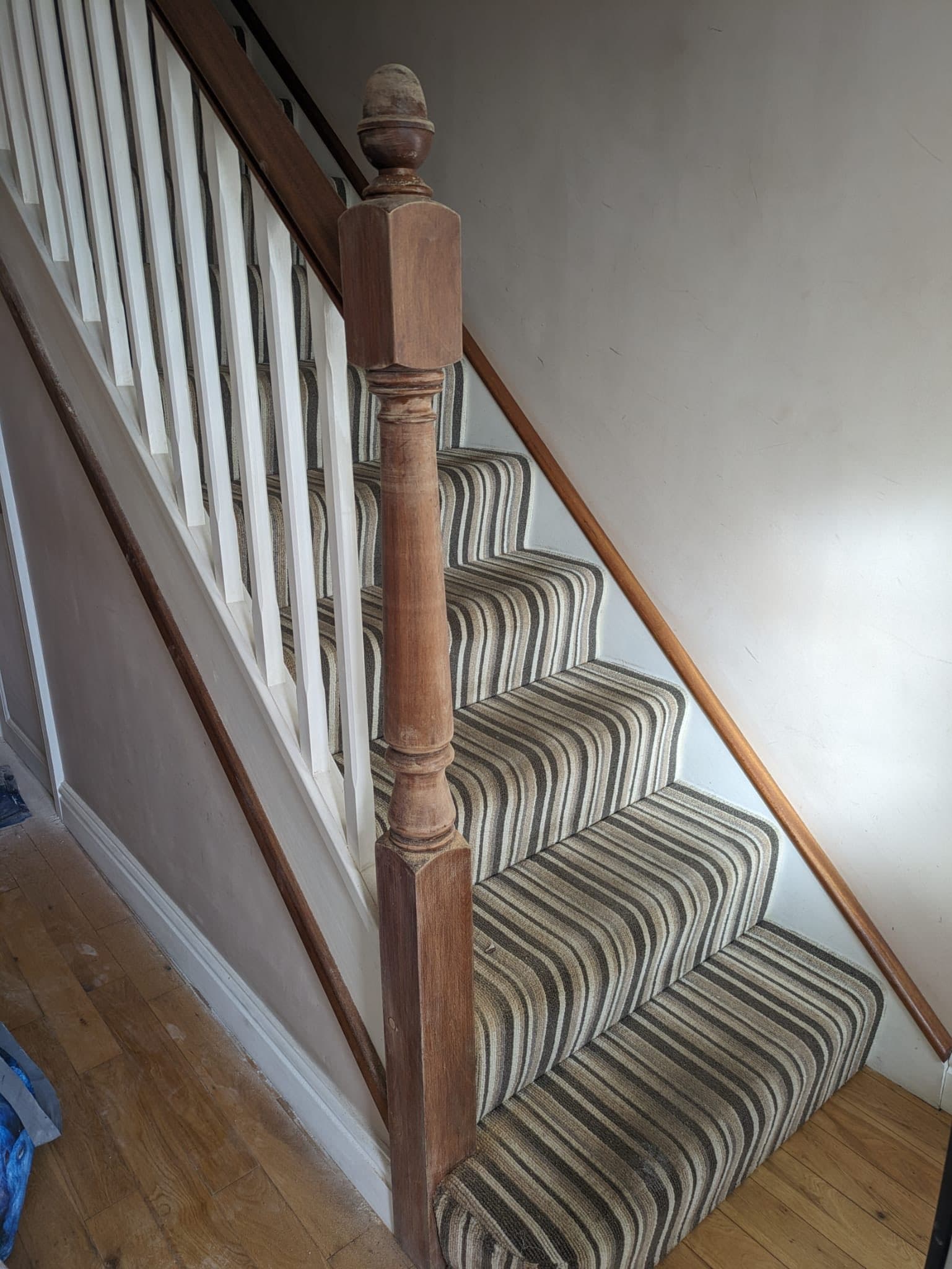 Hallway before decorating — bare wood newel, dingy walls