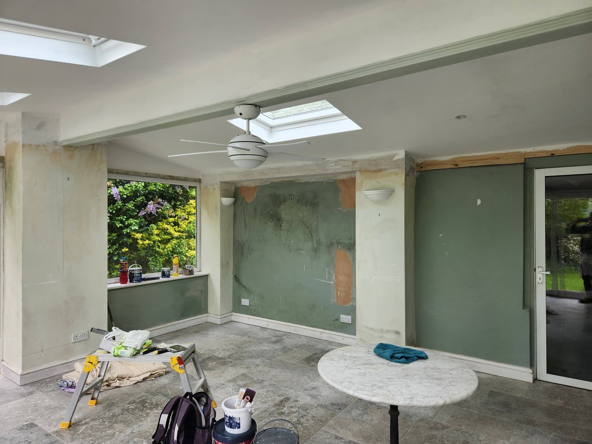 Conservatory before decorating — half-stripped walls